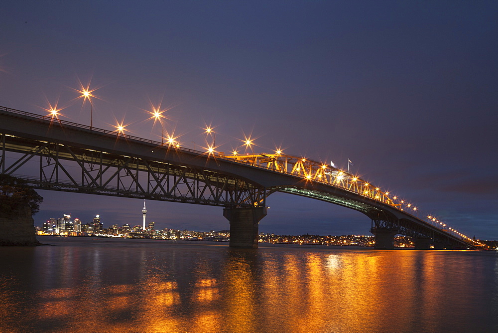 Auckland Harbour Bridge and skyline with Sky Tower in the evening light, Auckland City, North Island, New Zealand