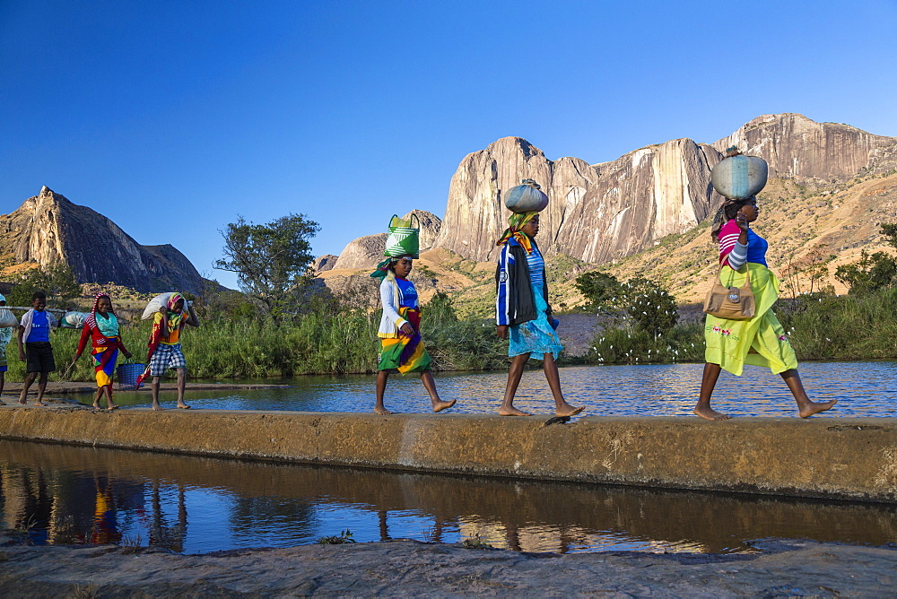 Madagascan women in front of the Tsaranoro Massif, highlands, South Madagascar, Africa