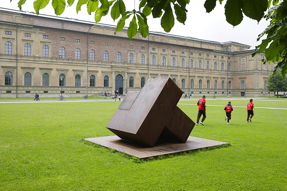 A sculpture and joggers in front of Museum Alte Pinakothek, Munich, Bavaria, Germany