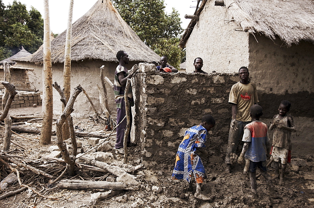 Villagers building an adobe hut, Magadala, Mali