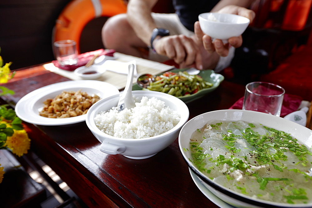 Man having lunch on a river steamer, Mekong river cruise, Cao Lanh, Dong Thap, Vietnam