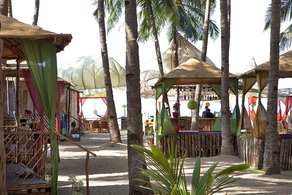 Beach resort with solar sails, bar and bungalows on the beach, Agonda, Goa, India