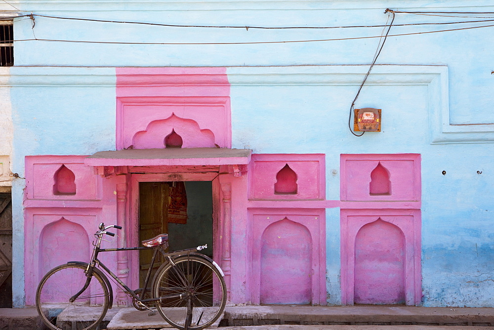 Old bike in front of colorful facade, Khajuraho, Madhya Pradesh, India