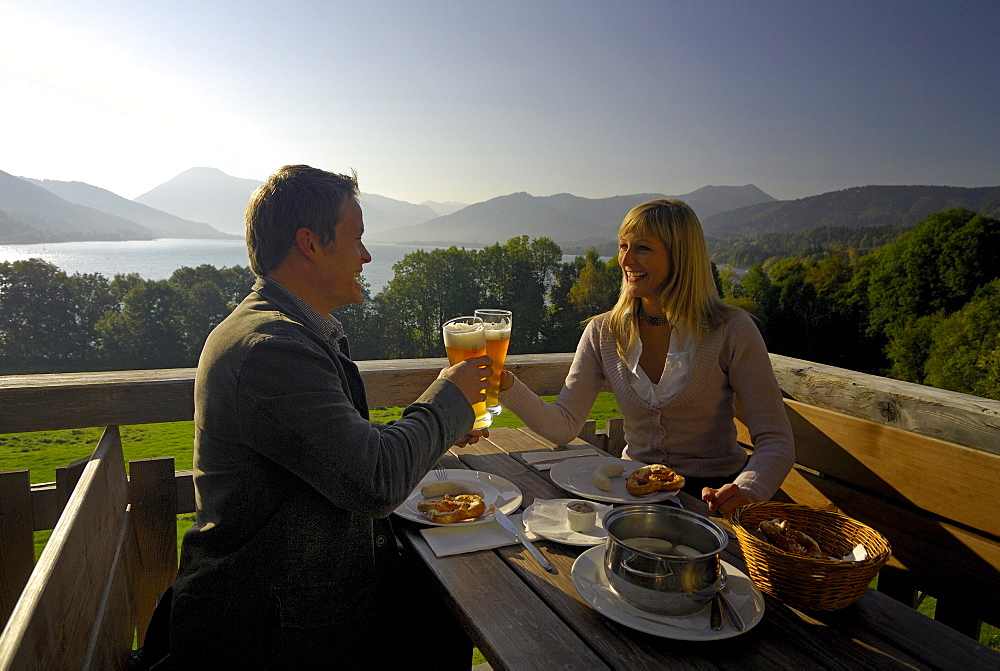 Young couple at a beer garden in the sunlight, lake Tegernsee, Bavaria, Germany, Europe