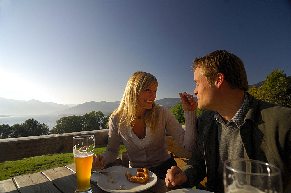 Couple in a beer garden near Lake Tegernsee, Near Gmund, Upper Bavaria, Bavaria, Germany