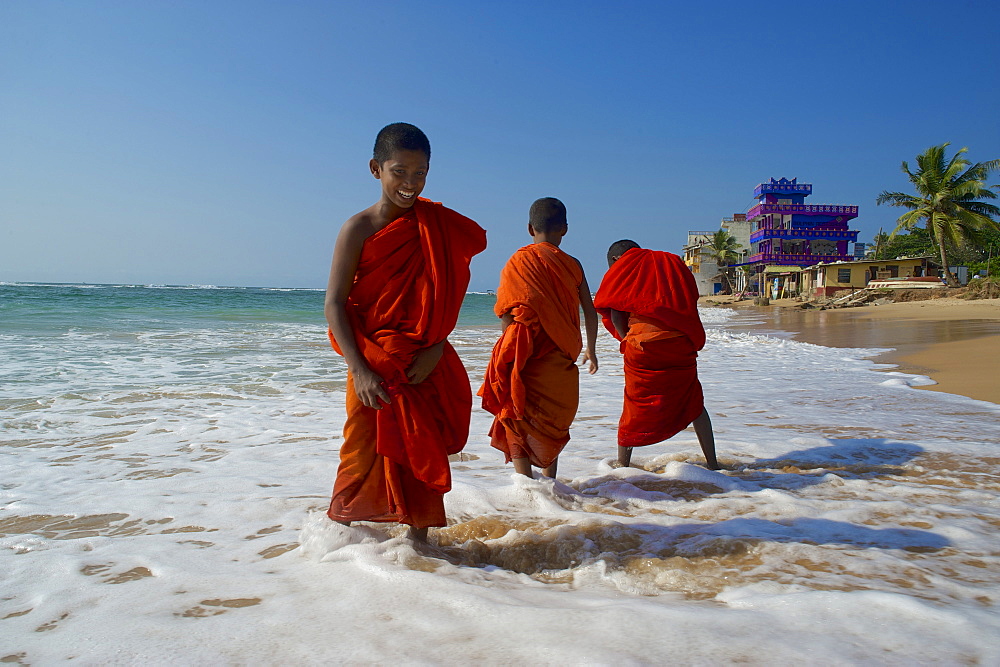 Buddhist novice on the beach at Hikkaduwa, Southwest coast, Sri Lanka, South Asia