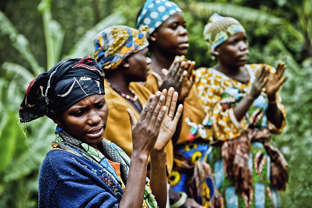 Women in a Pygmy village singing and clapping, Lake Bunyonyi, Uganda, Africa