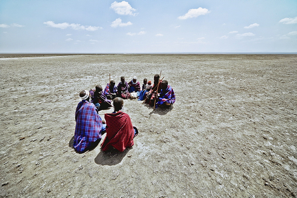 Massai's sitting in a circle in the plains, Ngorongoro, Tanzania, Africa