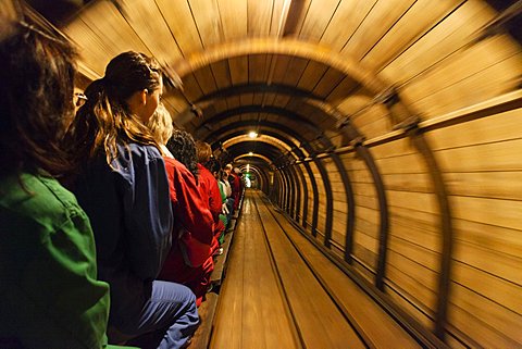 People on mine train in salt mine Grubenhund in the tunnel, Hallstatt, Salzkammergut, Upper Austria, Austria, Europe