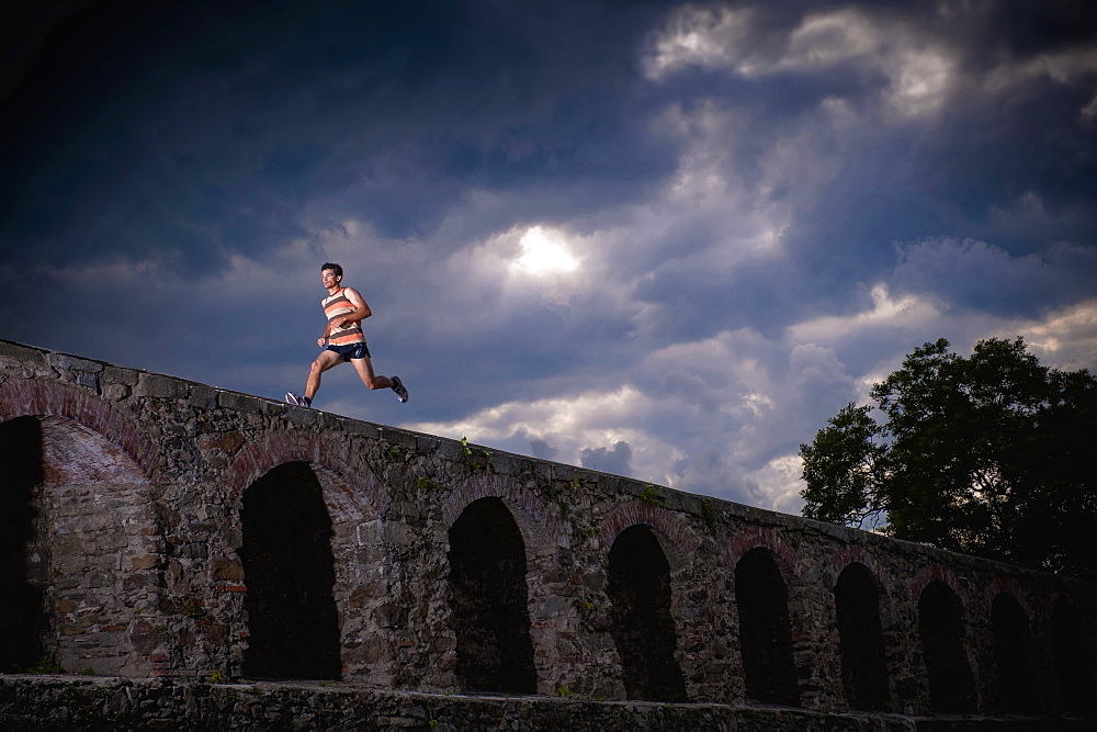 Man running along castle wall, Linz, Upper Austria, Austria