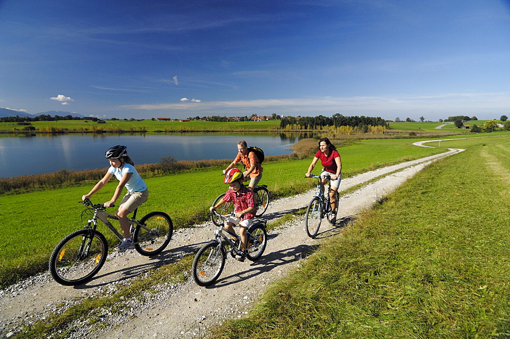 Family on a bike tour at lake Riegsee, near Murnau, Upper Bavaria, Bavaria, Deutschland