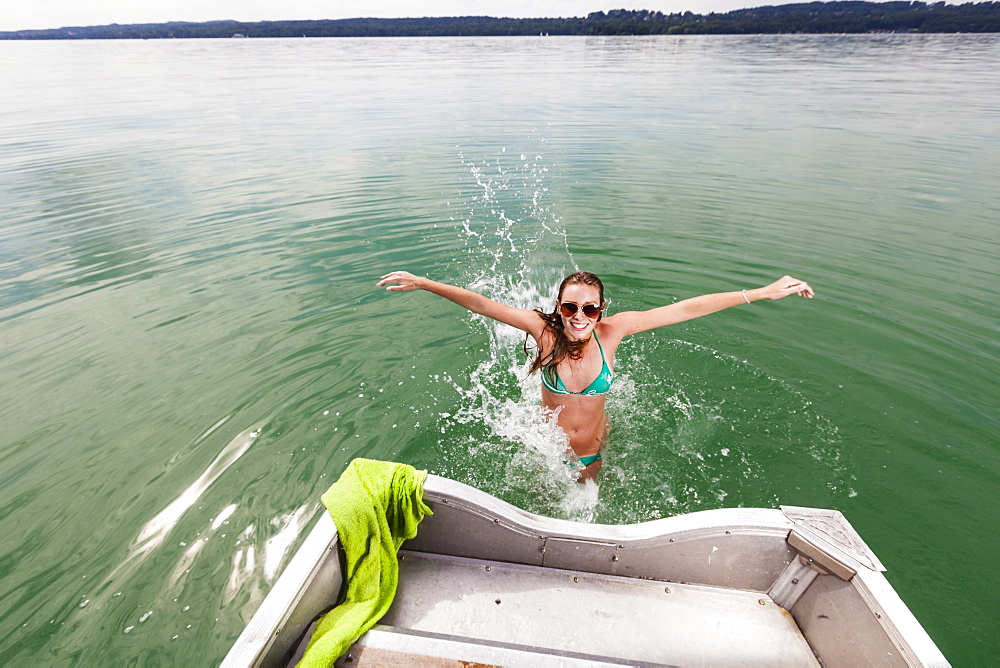 Young woman bathing in lake Starnberg, Bavaria, Germany