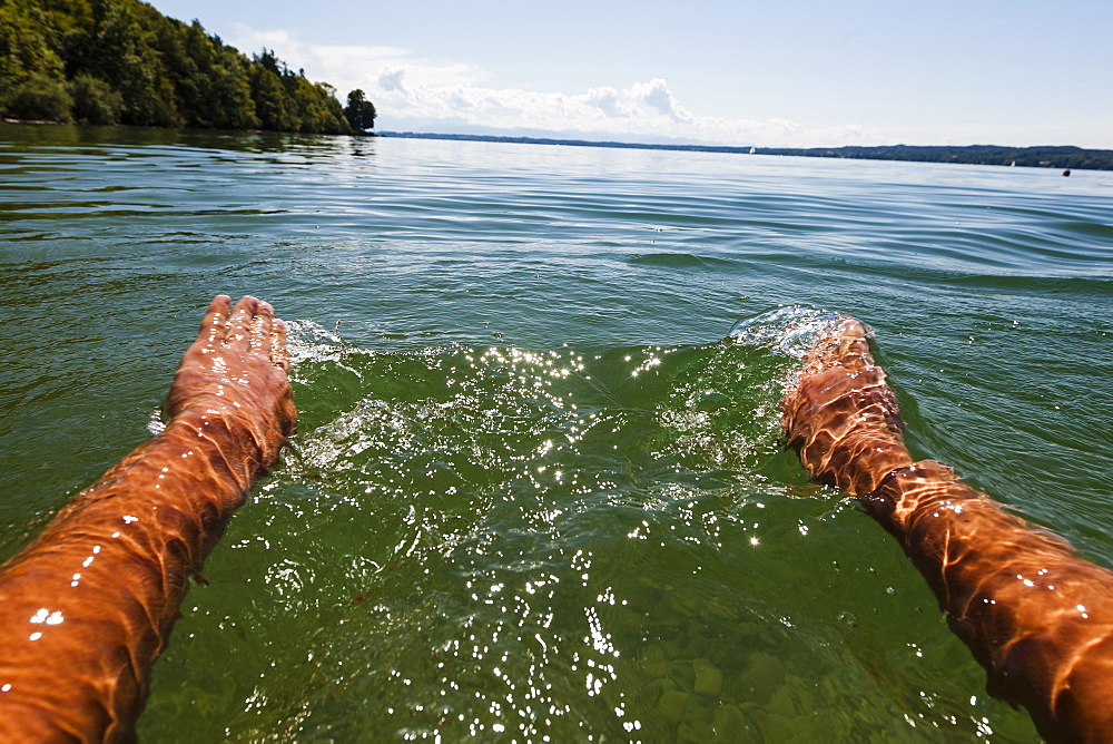 Man swimming in lake Starnberg, Bavaria, Germany