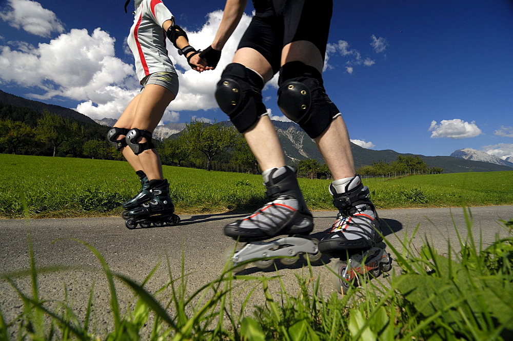 Couple on inline skates, Inline skating, near Imst, Tyrol, Austria