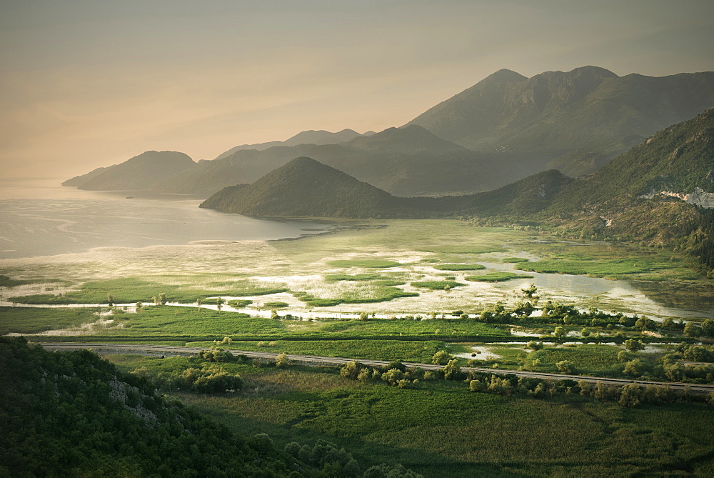 Dramatic morning light with view of Virpazar, the lake and mountains, Lake Skadar National Park, Montenegro, Western Balkan, Europe