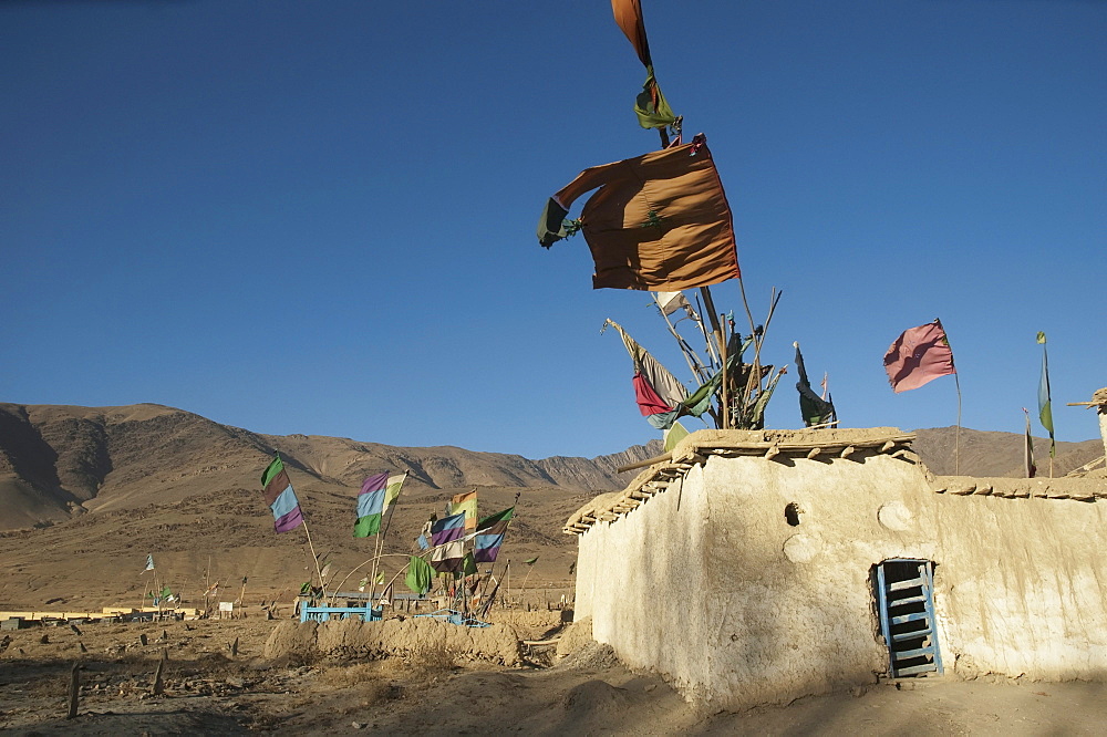 Flags fluttering in the wind over the Shrine of Khoja Mohammad Baba near Jalrez, Vardak Province, Afghanistan