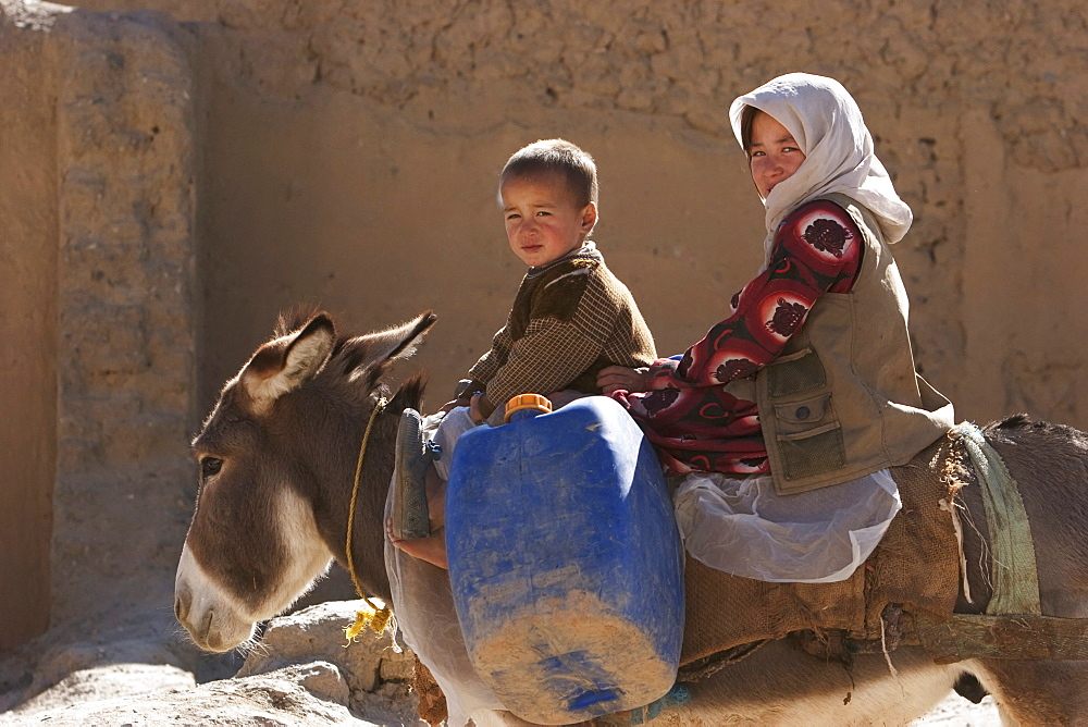 Boy and girl on a donkey in Bamiyan, Bamian Province, Afghanistan