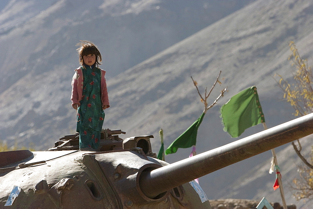 Girls playing on an abandoned Soviet tank in the Siagerd Valley, Parwan Province, Afghanistan