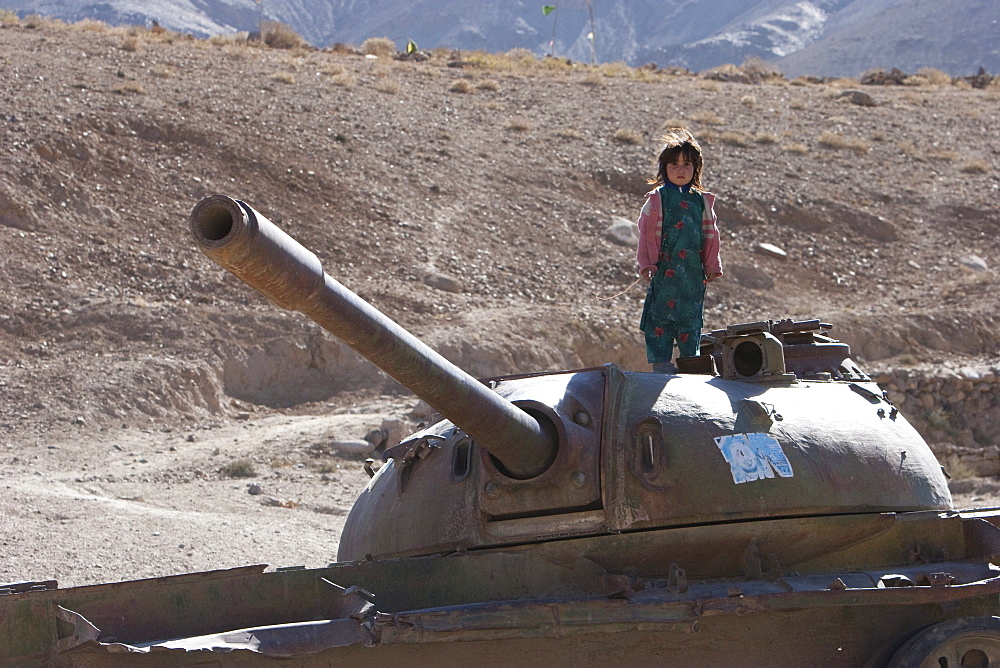 Girls playing on an abandoned Soviet tank in the Siagerd Valley, Parwan Province, Afghanistan