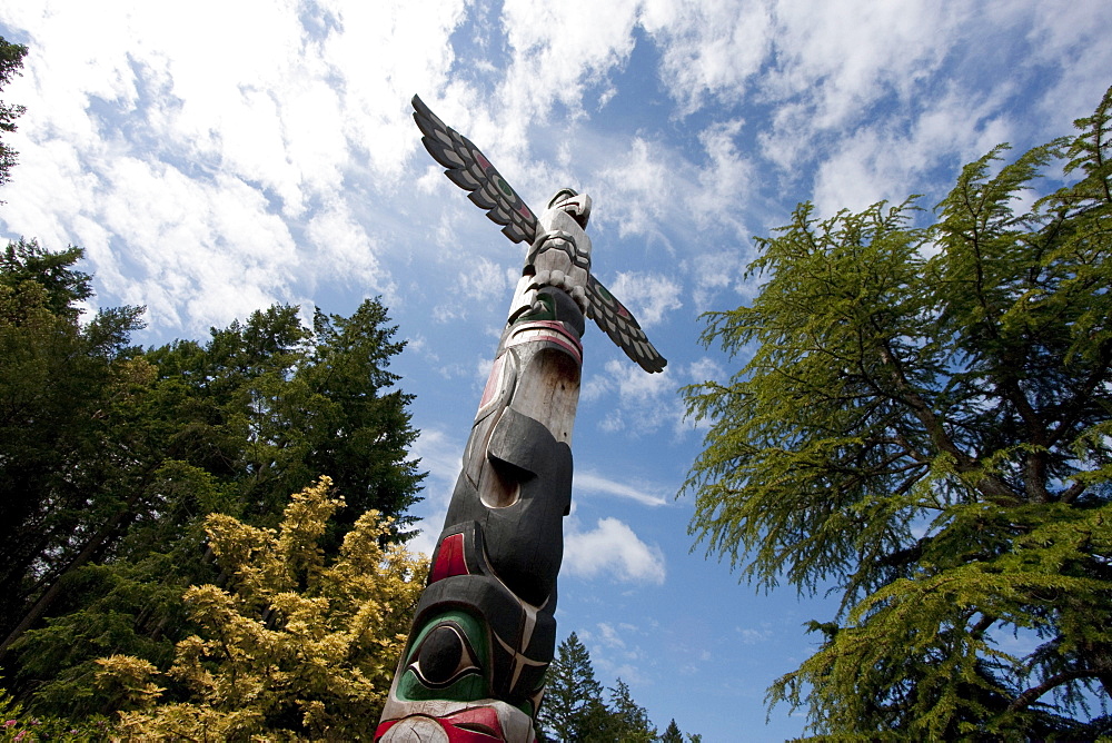 Contemporary Coast Salish totem pole carved by Doug LaFortune in Butchart Gardens, Victoria, British Columbia, Canada