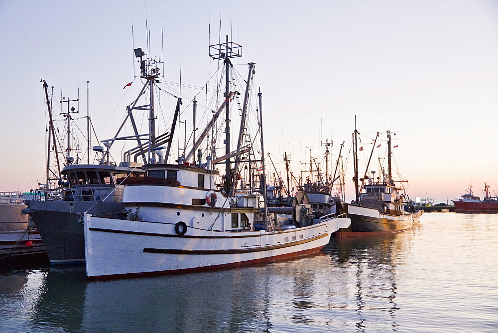 Fishing boats in the South Arm of the Fraser River by the Historic Fishing Village of Steveston at dusk, Richmond, British Columbia, Canada