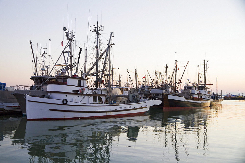 Fishing boats in the South Arm of the Fraser River by the Historic Fishing Village of Steveston at dusk, Richmond, British Columbia, Canada