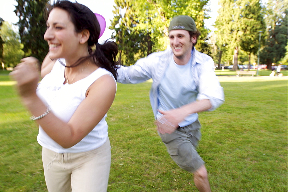 Couple Playing Frisbee in Park