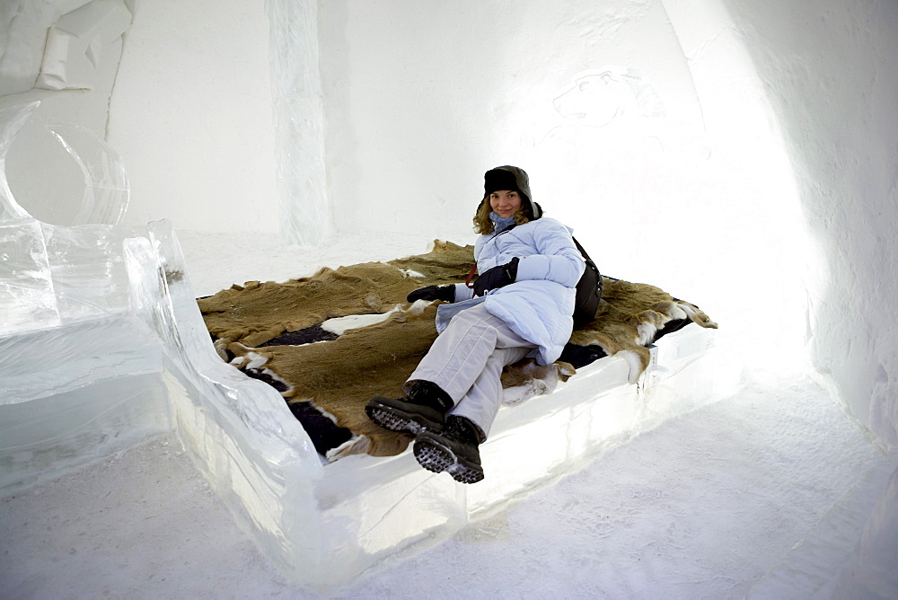 Woman in Ice Hotel, Lying on Bed with Furs, Quebec City, Quebec