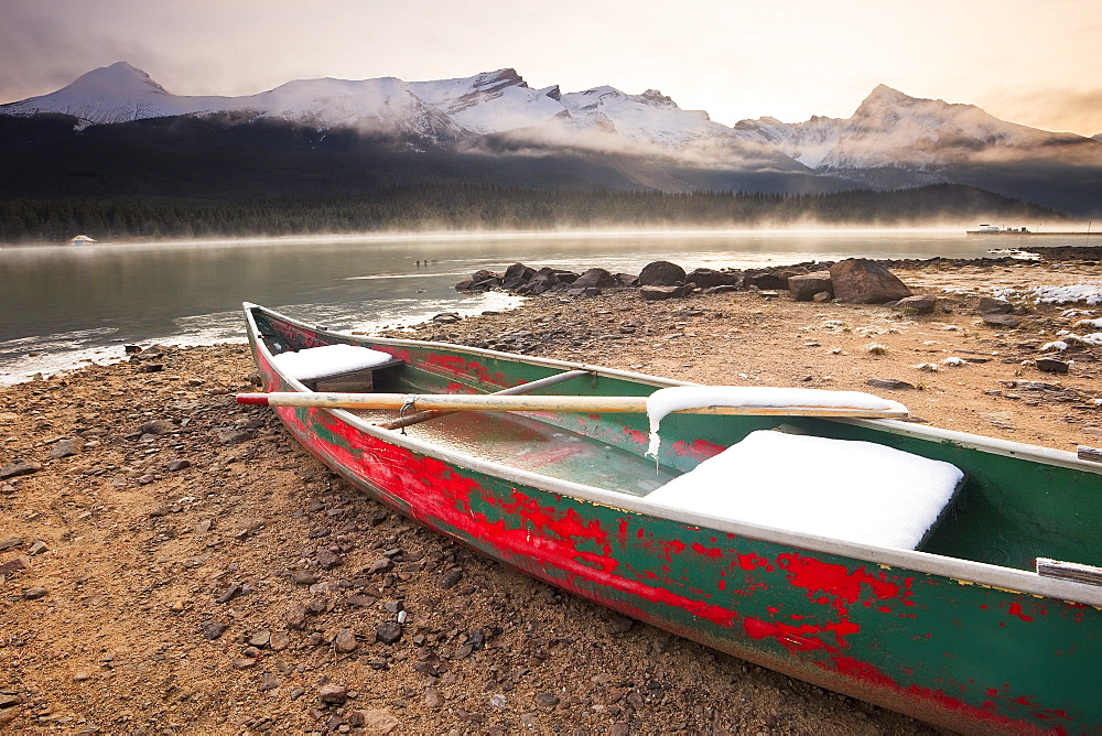 Canoe on misty fall morning, Maligne Lake, Jasper National Park, Alberta