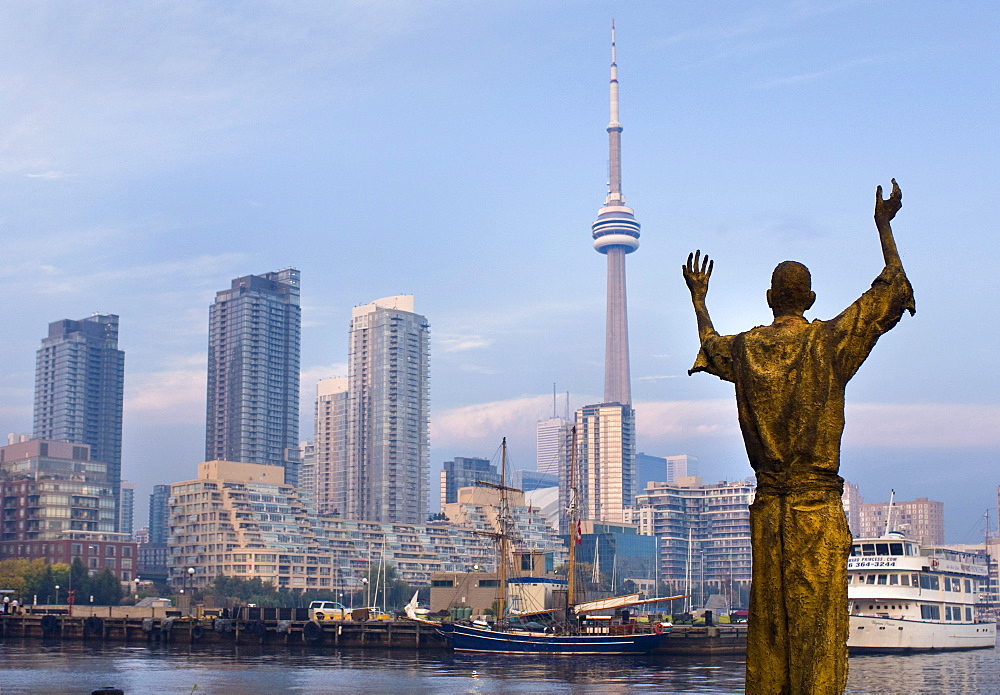 View of a statue with the CN Tower in the distance,Toronto, Ontario