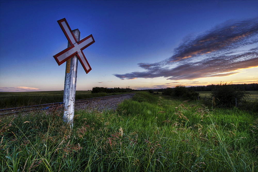 Railway crossing on a summer evening south of Bon Accord, Alberta.