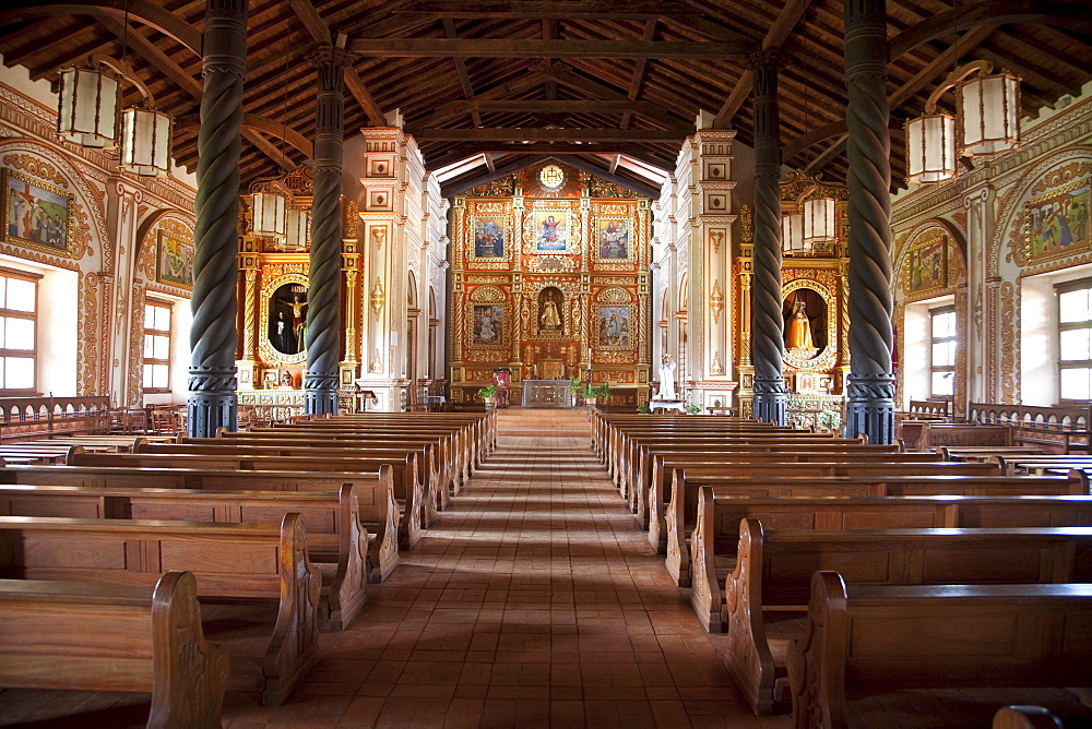 Nave and main altar with gilded and polychrome wood images carved in the Mestizo-Baroque style, Jesuit Mission of Concepcion, Santa Cruz Department, Bolivia