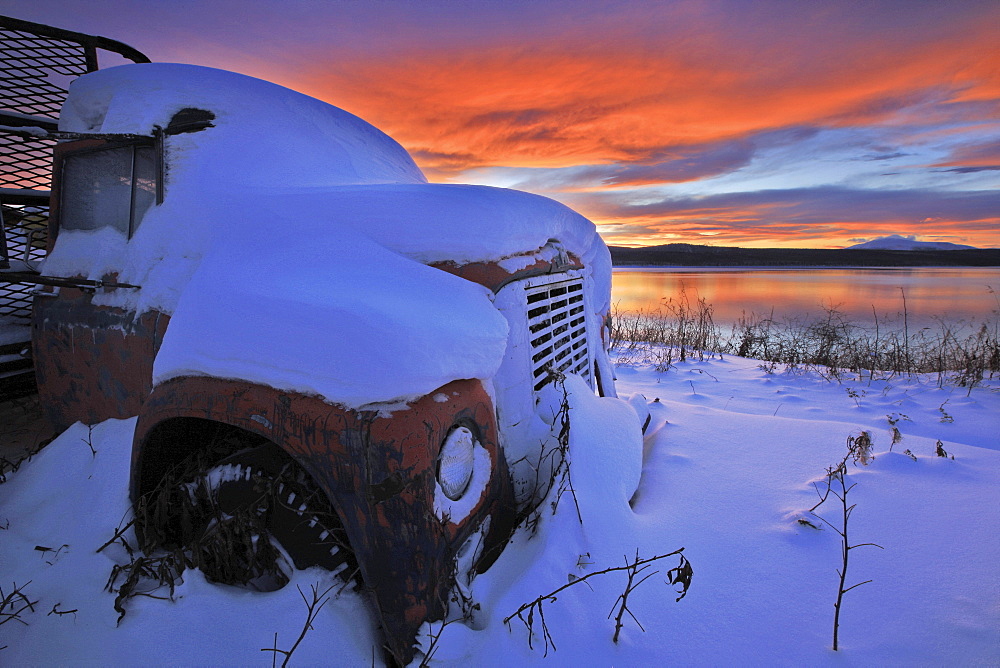 Sunset over abandoned truck along the shore of Teslin Lake, Yukon