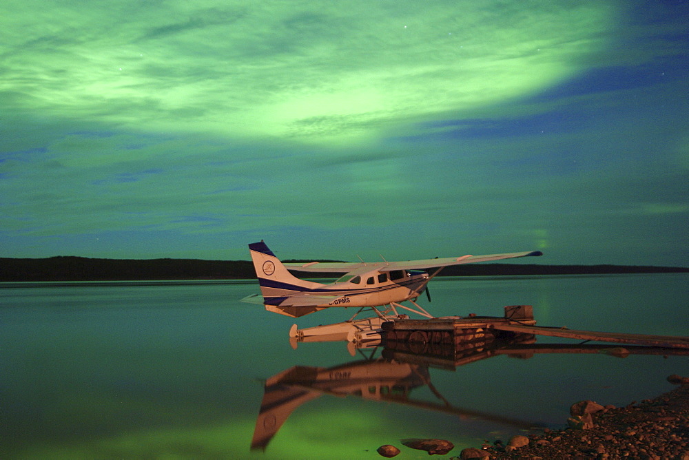 Aurora borealis or northern lights over float plane and Mackenzie River, Fort Simpson, Northwest Territories