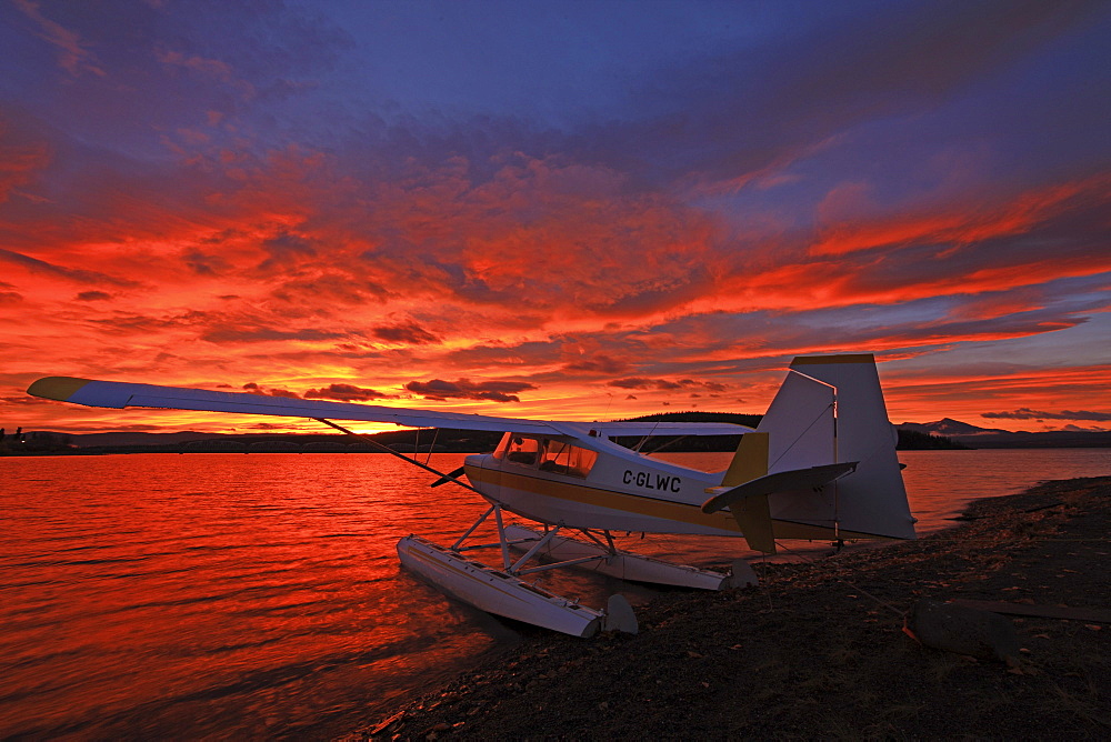 A float plane facing the sunrise over Teslin Lake, Yukon