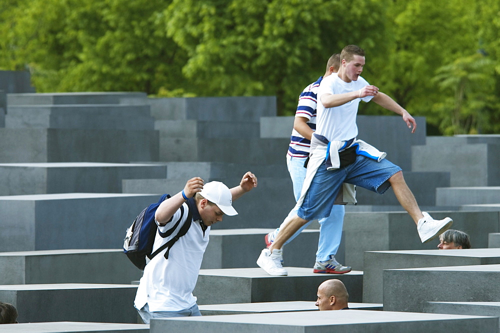 Boys playing on the stelae of the Memorial to the Murdered Jews of Europe, Berlin, Germany