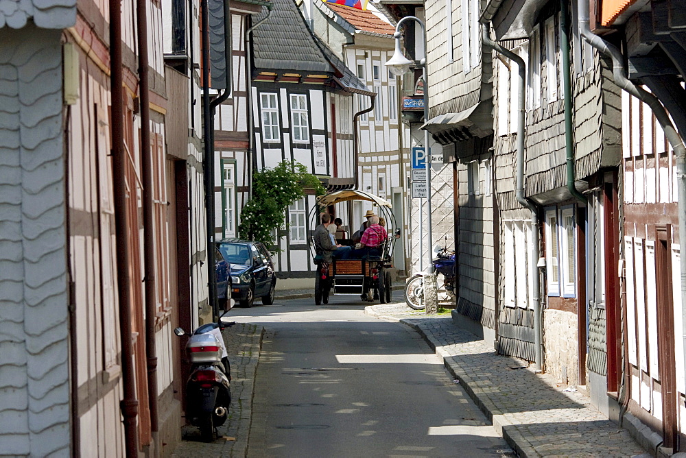 Horse cart tour on a street with half-timbered buildings, Goslar, Germany