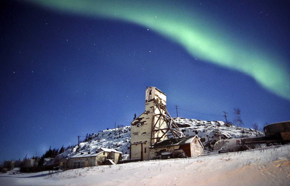 Old Gold Mine site in the NWT just north of Yellowknife with Northern Lights above, Canada Not Property Released