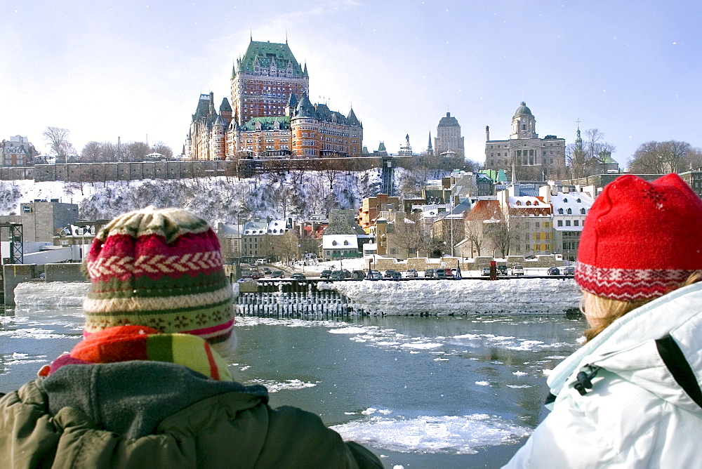 Two people looking at the frozen Saint Lawrence river and Chateau Frontenac, Quebec City