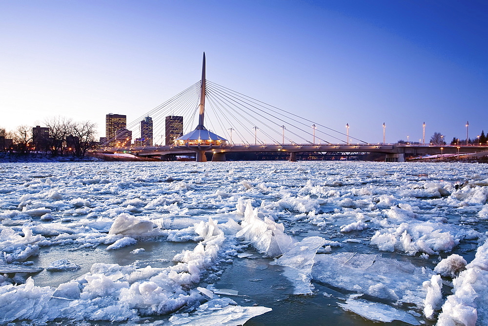 Ice on the Red River, Esplanade Riel Bridge and downtown in background, Winnipeg, Manitoba