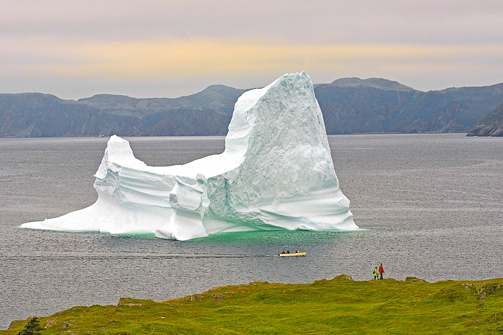 Hikers and Boaters view Iceberg in Trinity Bay off the Bonavista Peninsula of Eastern Newfoundland