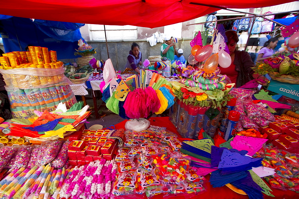 Party favours and decorations vendor at the Jueves de Comadres market during Carnaval Chapaco, Tarija, Bolivia