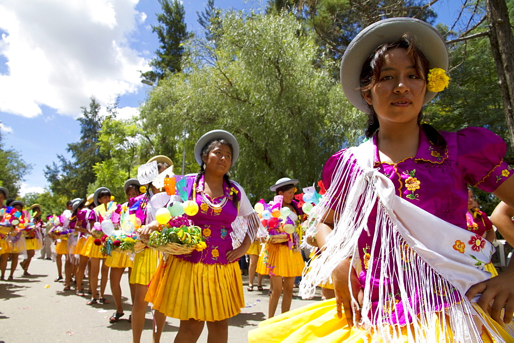Girls carrying festive baskets in the Entrada de Comadritas parade during the Carnaval Chapaco, Tarija, Bolivia