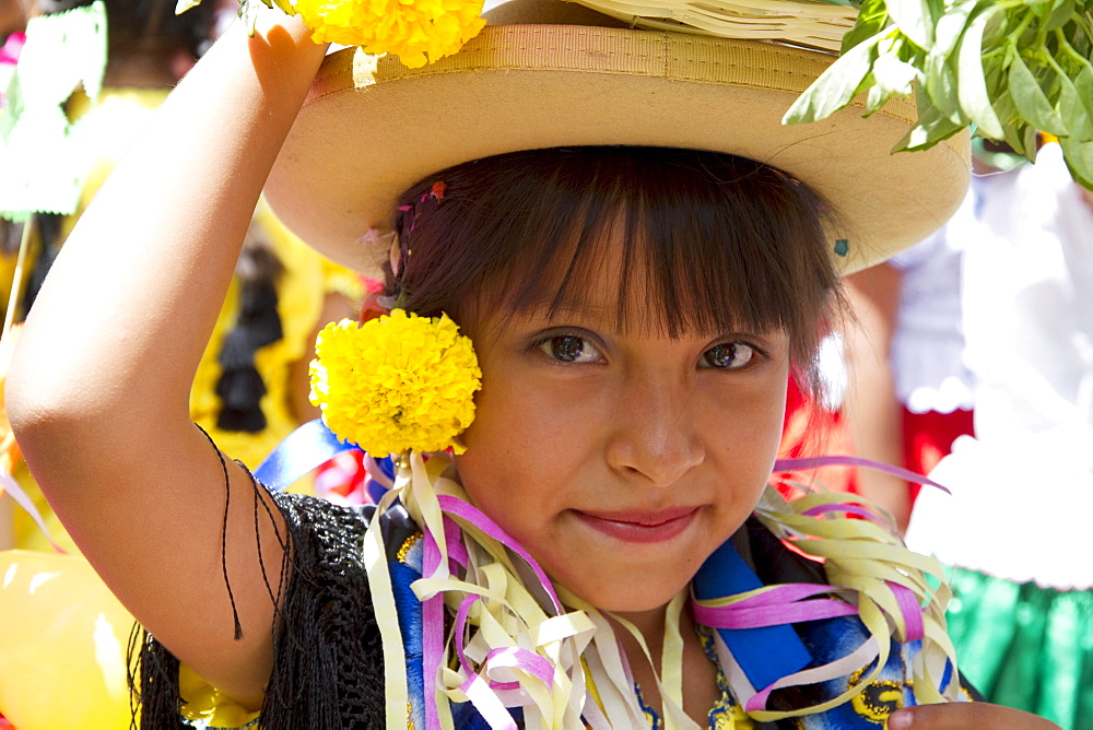 Girl carrying festive baskets in the Entrada de Comadritas parade during the Carnaval Chapaco, Tarija, Bolivia