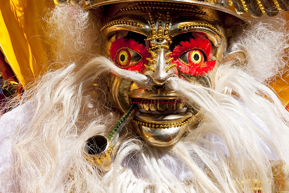 Morenada dancer wearing an elaborate mask and costume in the procession of the Carnaval de Oruro, Oruro, Bolivia