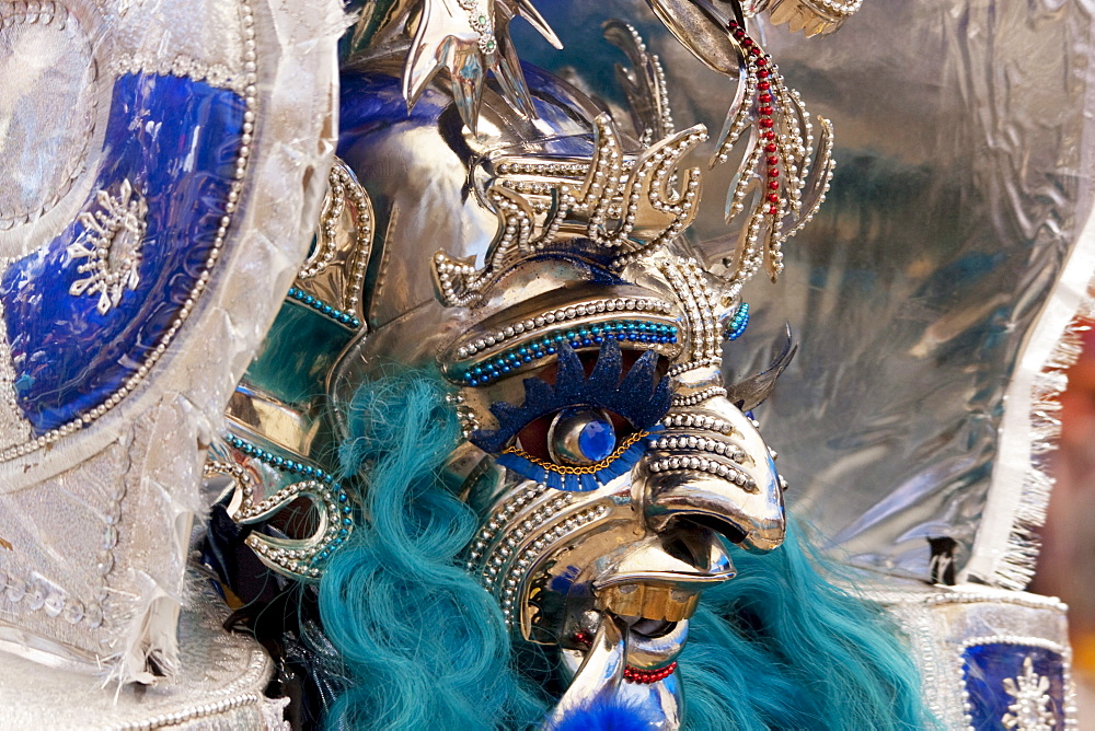 Morenada dancer wearing an elaborate mask and costume in the procession of the Carnaval de Oruro, Oruro, Bolivia