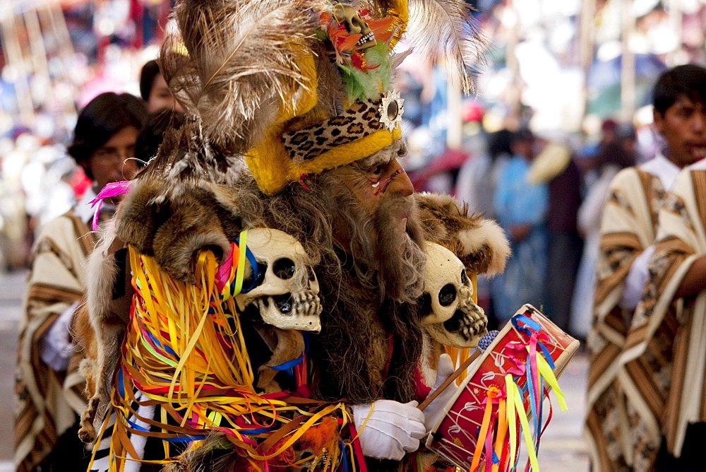 Tobas dancer wearing an elaborate mask, feather headdress and costume in the procession of the Carnaval de Oruro, Oruro, Bolivia