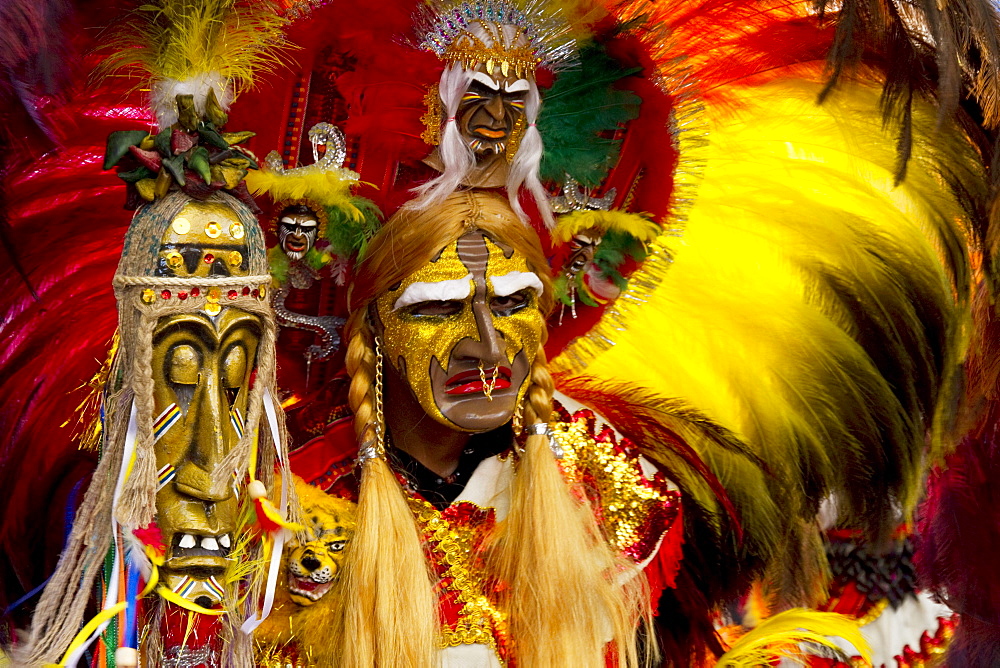 Tobas dancer wearing an elaborate mask, feather headdress and costume in the procession of the Carnaval de Oruro, Oruro, Bolivia