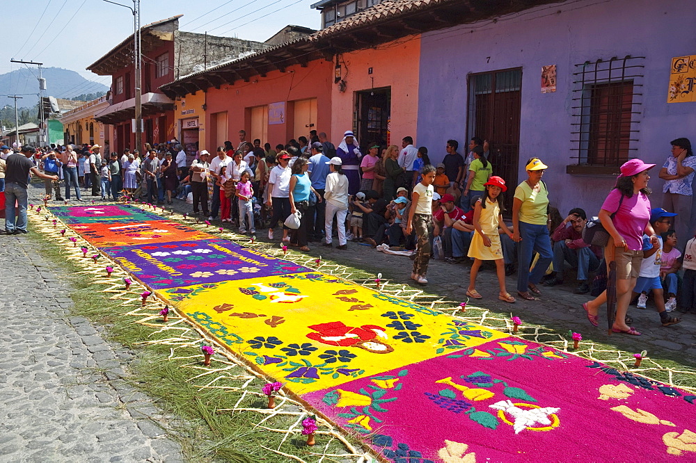 Carpet with Christian imagery made of sand & sawdust along the Good Friday processional route. Carpet-making is thought of as a sacrificial act, as the elaborate detail and time that go into the carpet making is a way for people to give something of themselves in memory of the crucifixion of Jesus. These carpets last on average 2 hours before they are destroyed by the many feet that march over them during a procession in Antigua Guatemala., Sacatepuquez, Guatemala