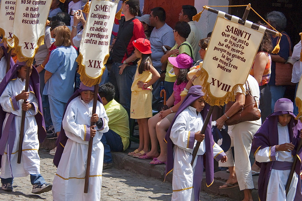 Children carrying standards at the Procession of the Holy Cross on Good Friday in Antigua Guatemala, Sacatepuquez, Guatemala